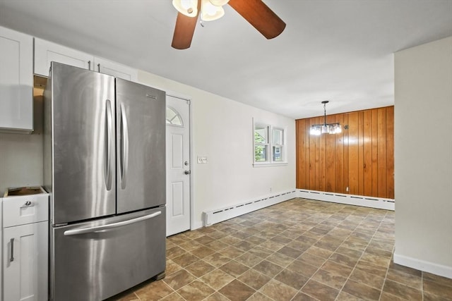 35 Woodland Rd, Leominster, MA 01453 - kitchen featuring freestanding refrigerator, a ceiling fan, wood walls, baseboard heating, and stone finish floors