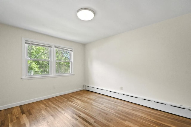 35 Woodland Rd, Leominster, MA 01453 - unfurnished room featuring a baseboard radiator and light wood-style floors