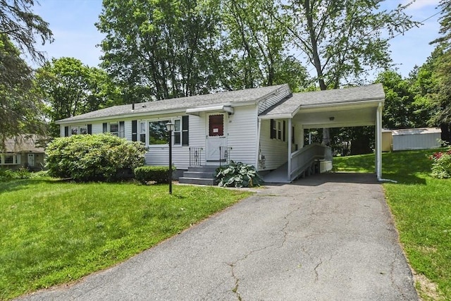 35 Woodland Rd, Leominster, MA 01453 - single story home featuring driveway, a front lawn, a carport, and a shingled roof