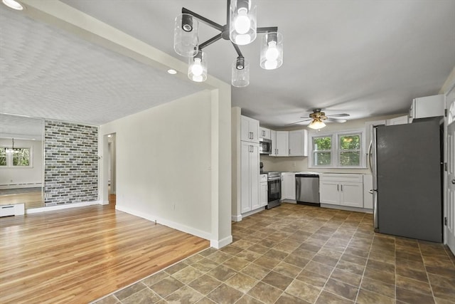 35 Woodland Rd, Leominster, MA 01453 - kitchen with appliances with stainless steel finishes, a ceiling fan, open floor plan, and white cabinets