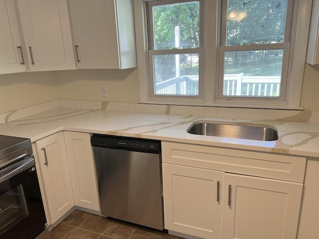 35 Woodland Rd, Leominster, MA 01453 - kitchen with stainless steel dishwasher, range with electric stovetop, white cabinetry, light stone counters, and dark tile patterned flooring