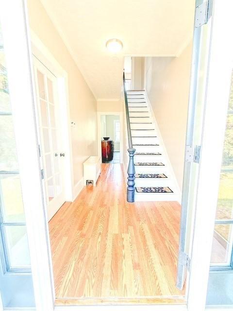 68 Forest St, Lowell, MA 01851 - stairs featuring wood finished floors and ornamental molding