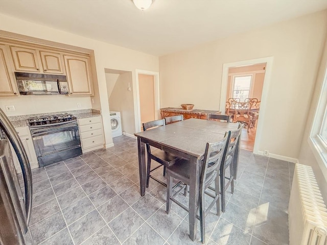 68 Forest St, Lowell, MA 01851 - dining area featuring washer / dryer and radiator heating unit