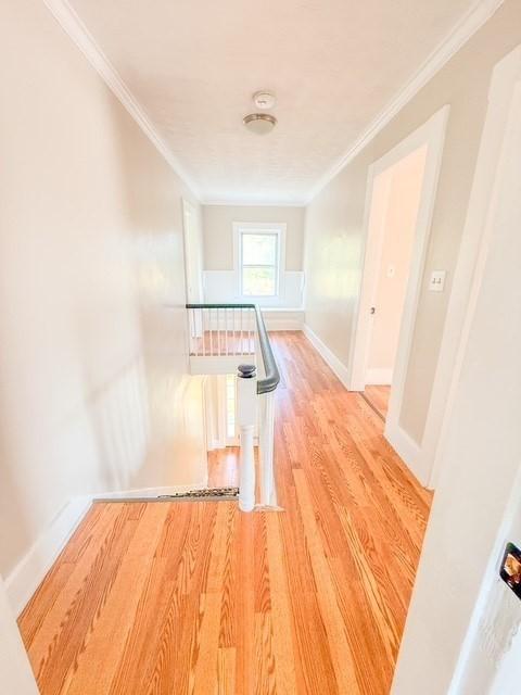 68 Forest St, Lowell, MA 01851 - hallway featuring ornamental molding and wood finished floors