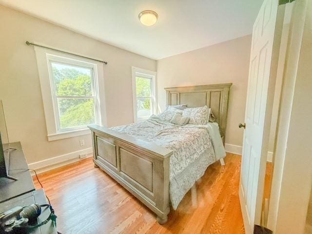 68 Forest St, Lowell, MA 01851 - bedroom with light wood-style floors and baseboards