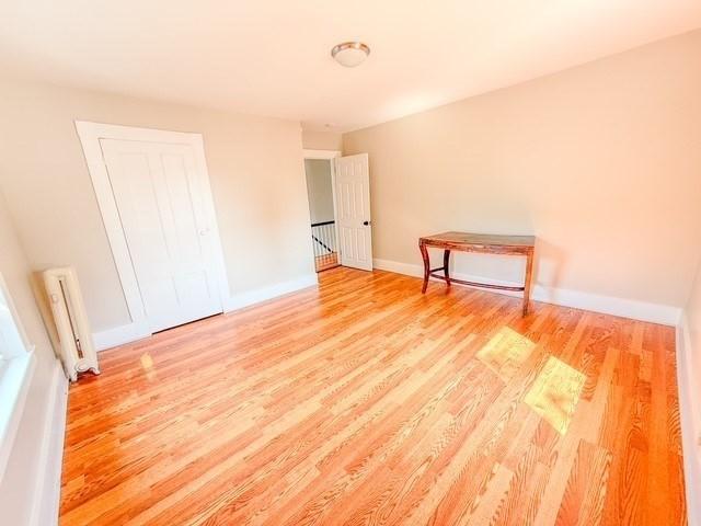 68 Forest St, Lowell, MA 01851 - spare room featuring wood finished floors and baseboards