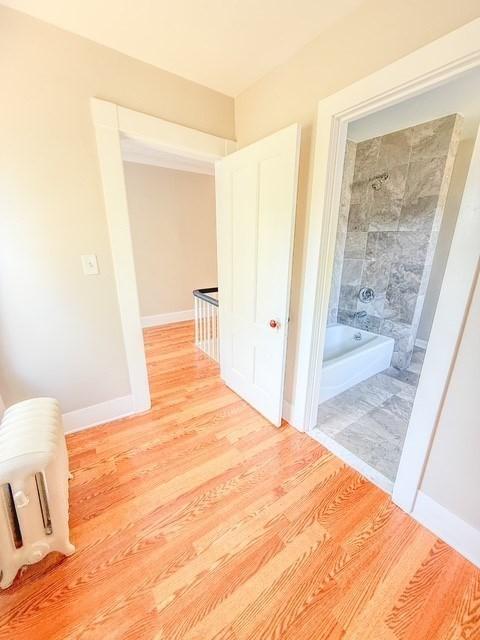 68 Forest St, Lowell, MA 01851 - hallway with light wood-style flooring and baseboards