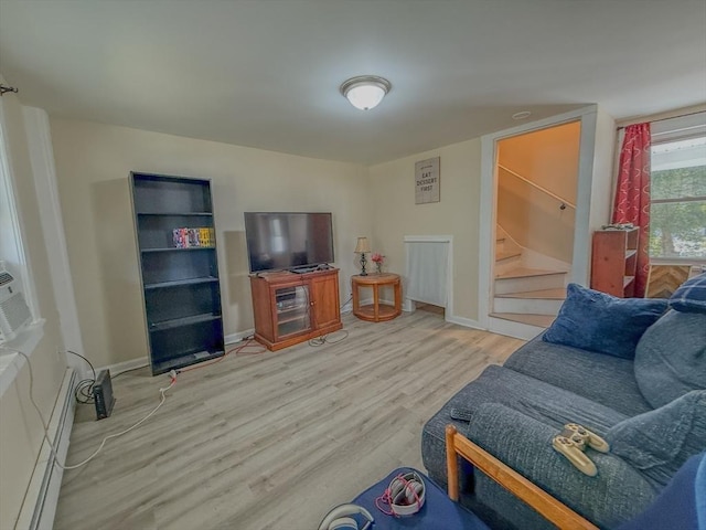68 Forest St, Lowell, MA 01851 - living area with wood finished floors, stairway, and baseboard heating