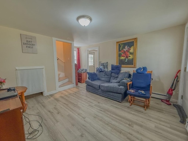 68 Forest St, Lowell, MA 01851 - living room featuring stairs, light wood-type flooring, and a baseboard radiator
