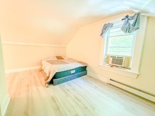 68 Forest St, Lowell, MA 01851 - unfurnished bedroom with a baseboard heating unit, wood finished floors, lofted ceiling, and cooling unit
