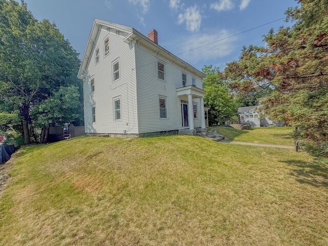 68 Forest St, Lowell, MA 01851 - rear view of property featuring a chimney and a yard