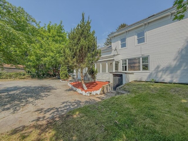 68 Forest St, Lowell, MA 01851 - rear view of property featuring a yard