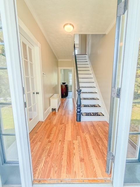 68 Forest St, Lowell, MA 01851 - stairs featuring crown molding and wood finished floors