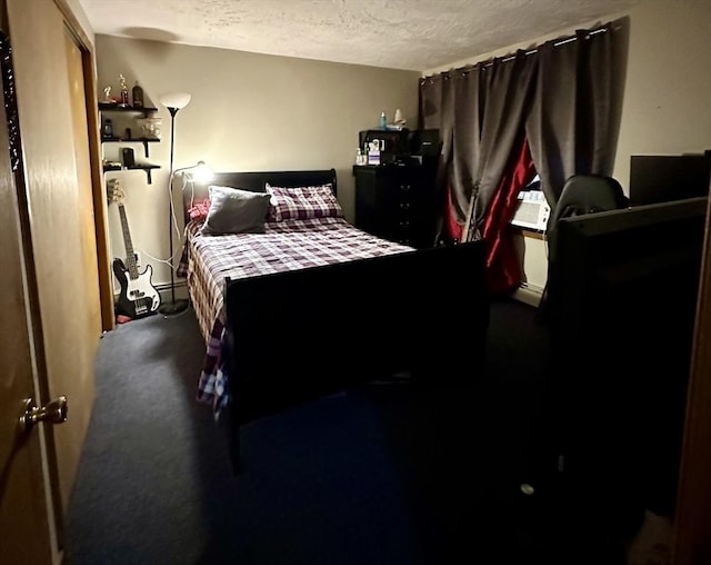 334 Howard St Unit 5, Lawrence, MA 01841 - bedroom featuring a textured ceiling, a baseboard heating unit, and carpet floors