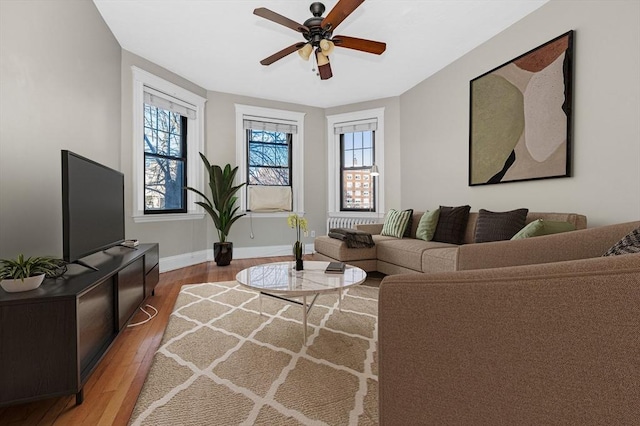 living room featuring hardwood / wood-style flooring and ceiling fan