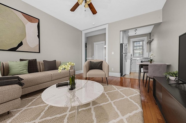 living room with ceiling fan and hardwood / wood-style flooring