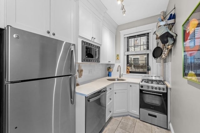 kitchen with stainless steel appliances, backsplash, white cabinets, and sink