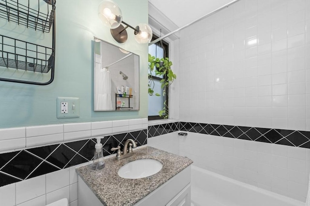 bathroom with walk in shower, vanity, and tile walls