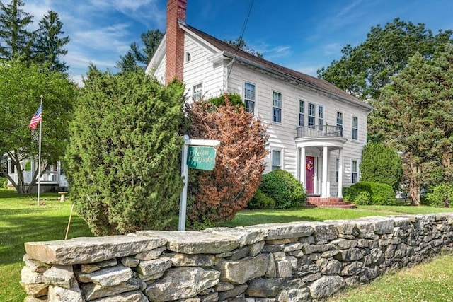 colonial home featuring a front yard