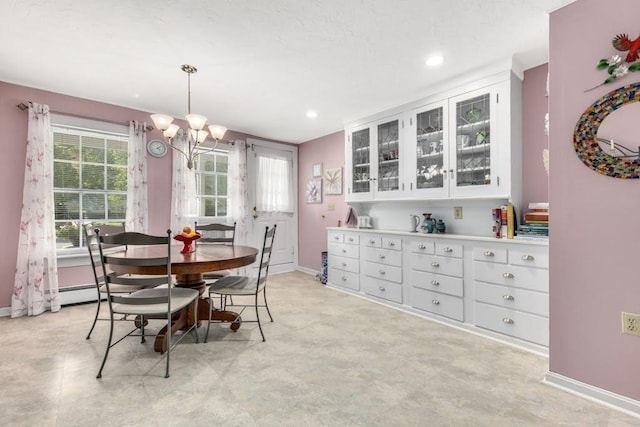 dining area with a notable chandelier and baseboard heating