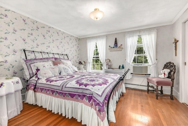 bedroom featuring multiple windows, wood-type flooring, and crown molding