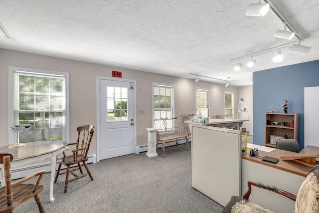 office with a baseboard heating unit, carpet floors, and a textured ceiling