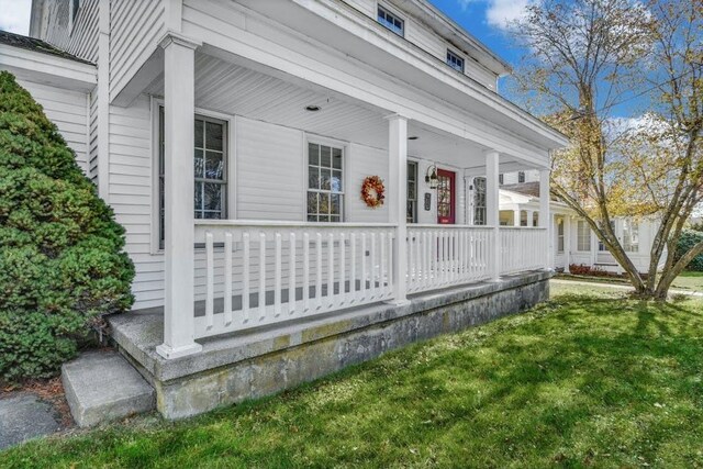 exterior space with a lawn and covered porch