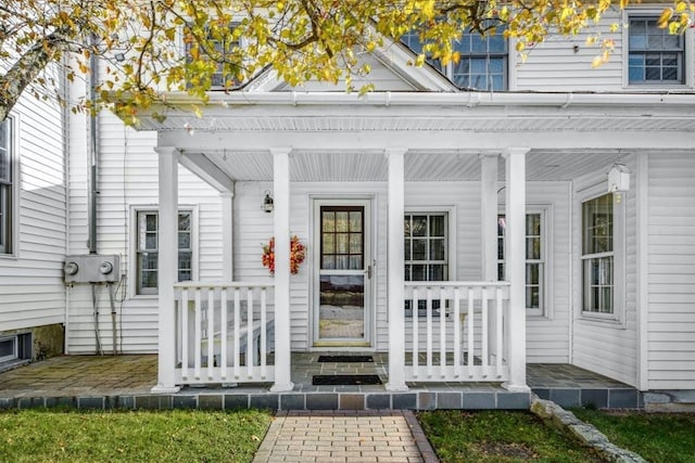 view of exterior entry with covered porch