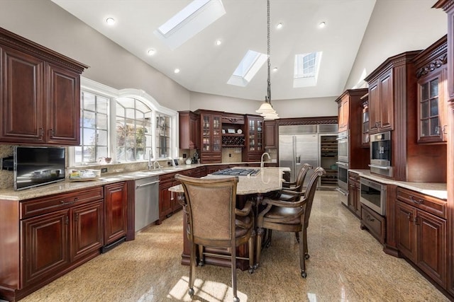 150 Horseneck Rd, Dartmouth, MA 02748 - kitchen with built in appliances, a skylight, a center island with sink, pendant lighting, and granite tiled floors