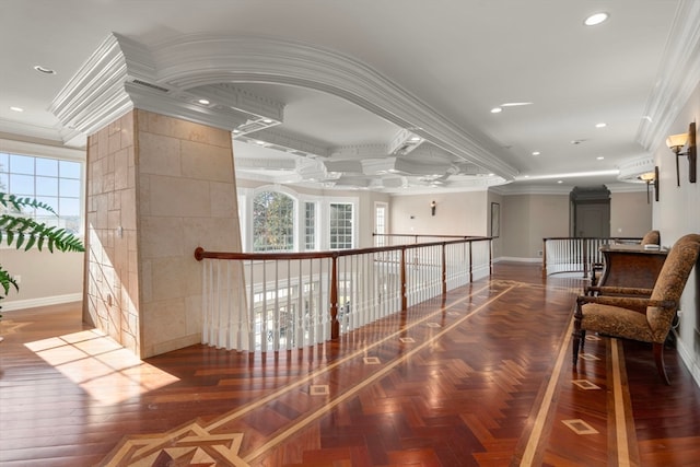 corridor with ornamental molding and a wealth of natural light