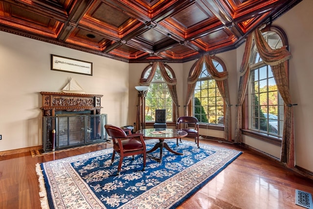 living area with crown molding, coffered ceiling, beamed ceiling, and plenty of natural light