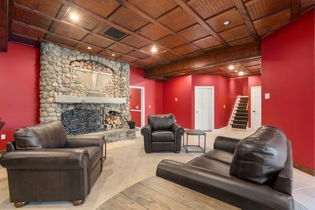 living room with a stone fireplace, light colored carpet, and wooden ceiling