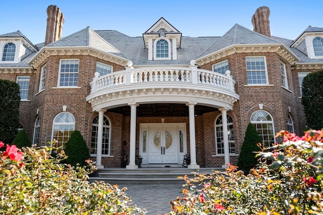 view of front facade with covered porch and a balcony