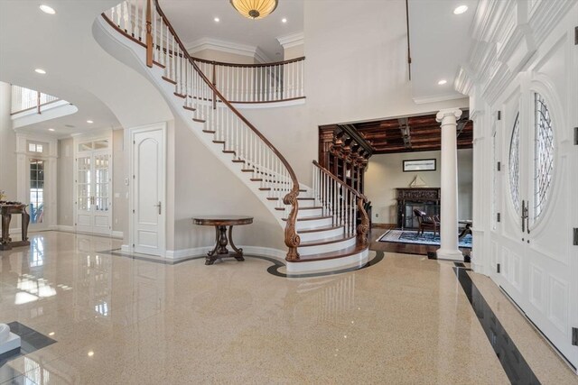 150 Horseneck Rd, Dartmouth, MA 02748 - foyer entrance featuring a high ceiling, ornate columns, baseboards, stairway, and a fireplace