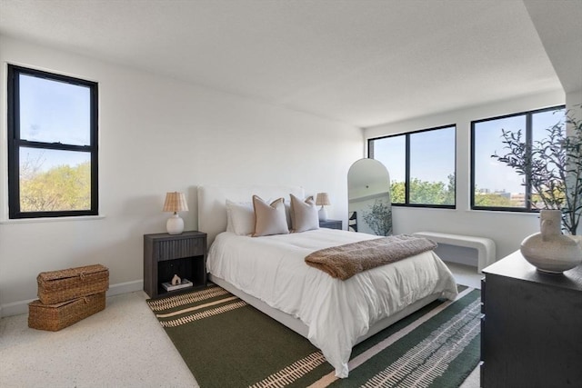 carpeted bedroom featuring baseboards