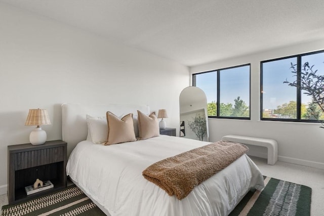 bedroom featuring carpet floors and baseboards
