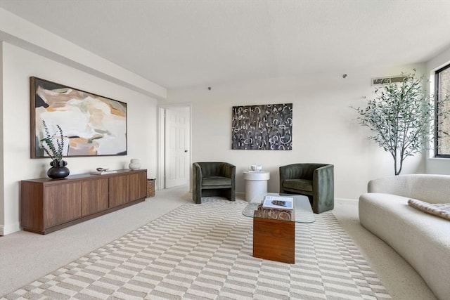 living room featuring light colored carpet and baseboards