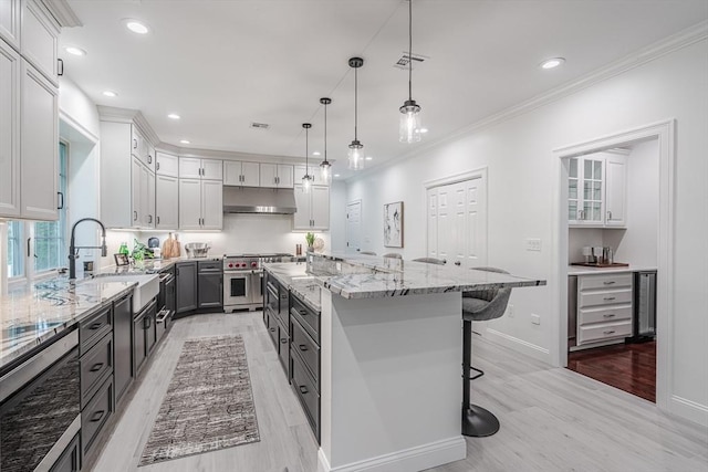 261 E St, Foxboro, MA 02035 - kitchen with double oven range, beverage cooler, light wood-type flooring, under cabinet range hood, and recessed lighting