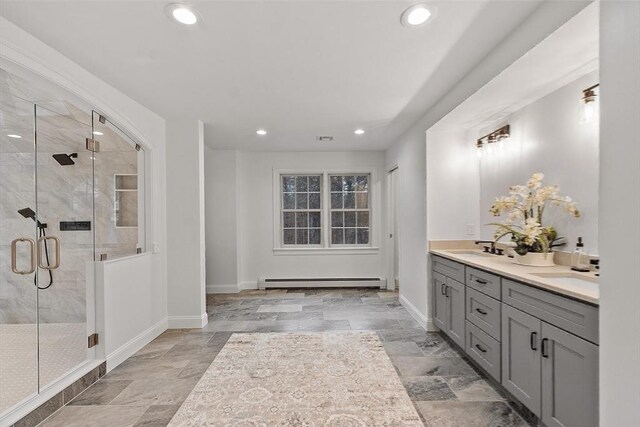 261 E St, Foxboro, MA 02035 - full bathroom featuring a baseboard heating unit, a shower stall, recessed lighting, double vanity, and stone finish flooring