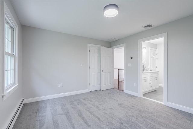 261 E St, Foxboro, MA 02035 - unfurnished bedroom featuring a baseboard heating unit, carpet flooring, and connected bathroom