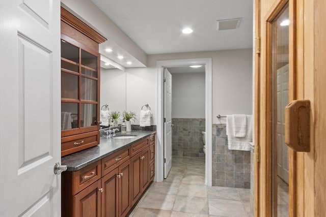 261 E St, Foxboro, MA 02035 - bathroom featuring vanity, tile walls, recessed lighting, wainscoting, and tile patterned flooring