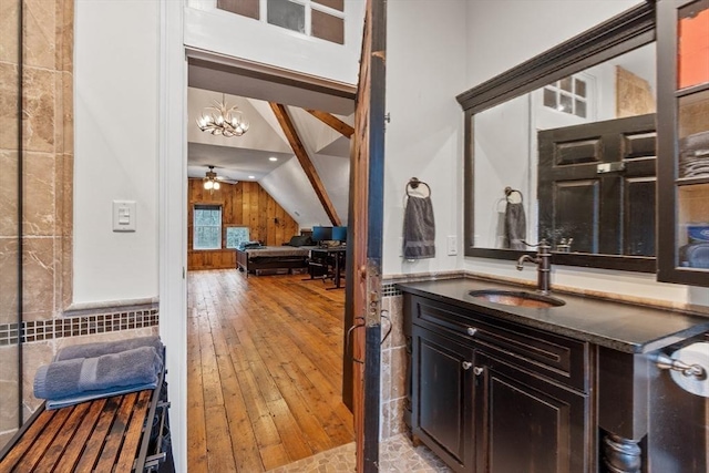 261 E St, Foxboro, MA 02035 - bathroom featuring lofted ceiling, wood-type flooring, vanity, a ceiling fan, and a chandelier