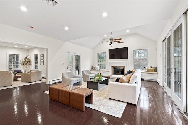 261 E St, Foxboro, MA 02035 - living area with a baseboard heating unit, a glass covered fireplace, plenty of natural light, lofted ceiling, and hardwood / wood-style floors