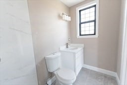 bathroom with vanity, toilet, and tile patterned floors