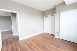 unfurnished bedroom featuring a closet and hardwood / wood-style floors