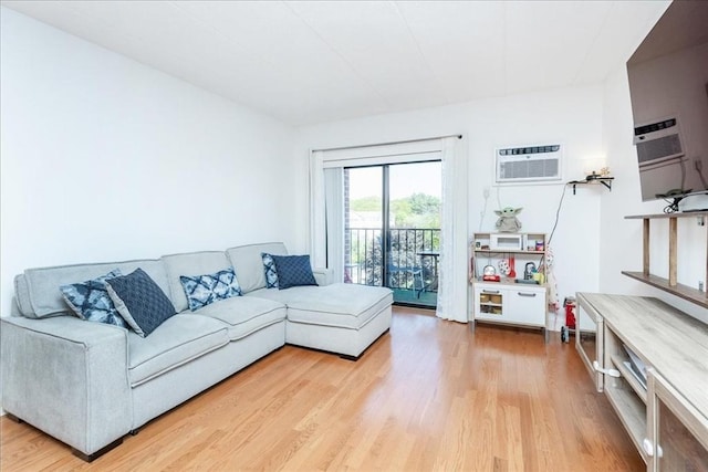 living area featuring a wall unit AC and light wood finished floors