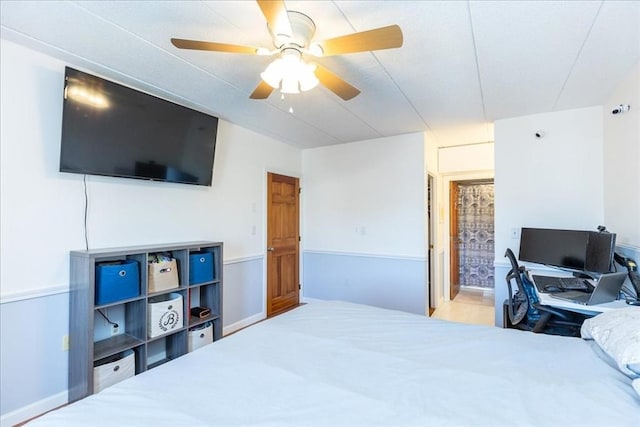 bedroom with connected bathroom and ceiling fan