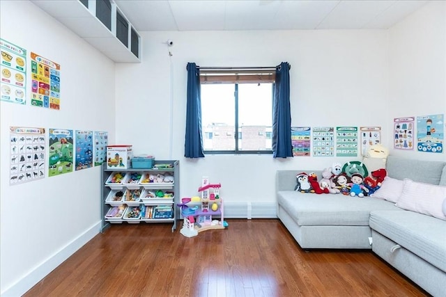recreation room with hardwood / wood-style floors and baseboards