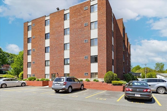 view of building exterior with uncovered parking
