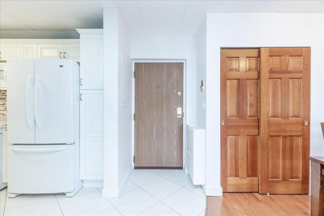interior space with baseboards and light tile patterned flooring